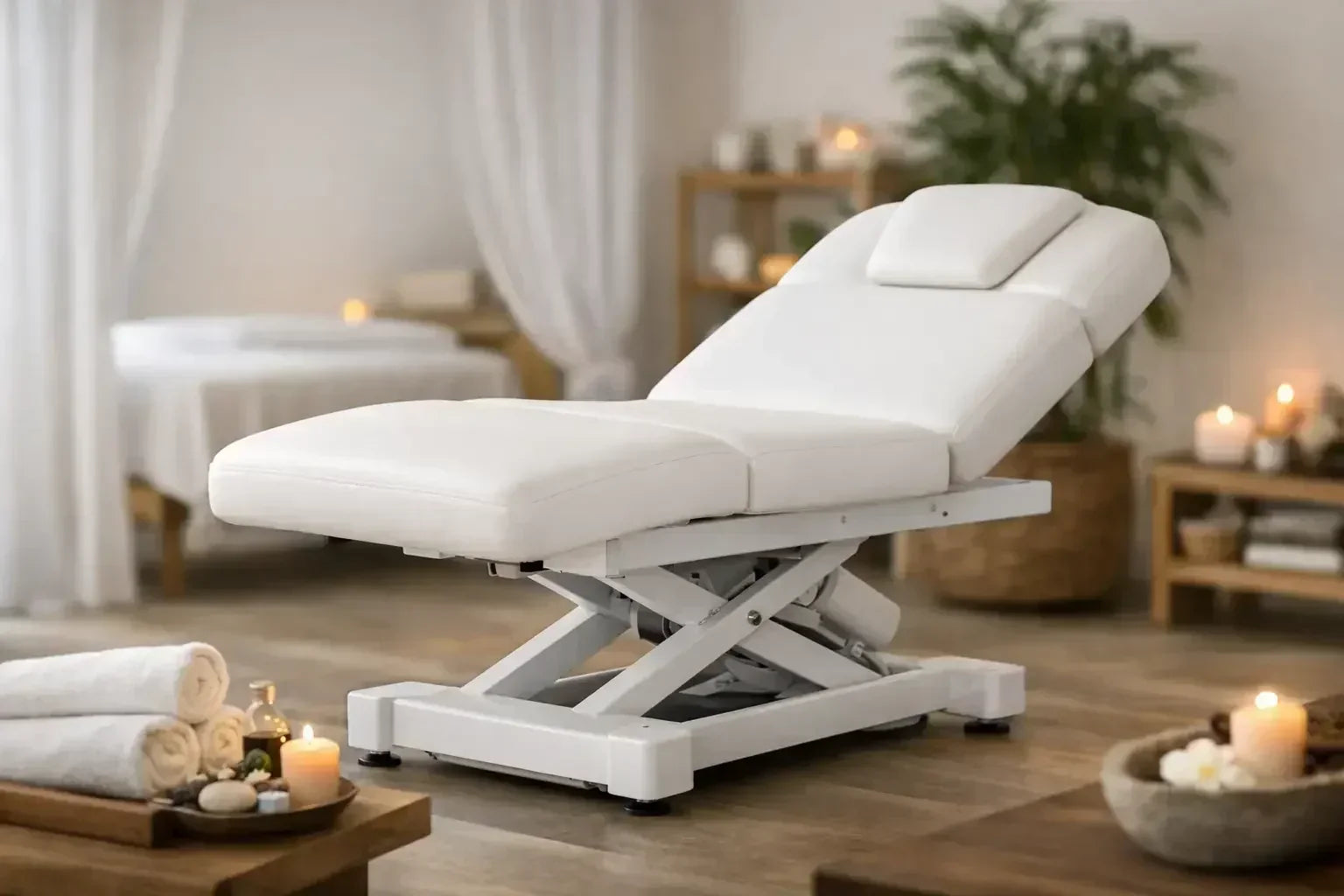A white electric life salon table with a salon top, in a soft room with wooden floors an candles.