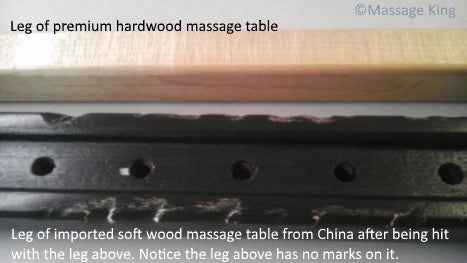 Two wooden table leg pieces from a massage table, one is black and one is natural colored. 