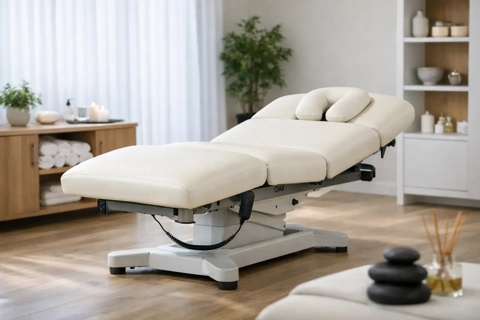 An electric lift salon top spa table in a spa room setting