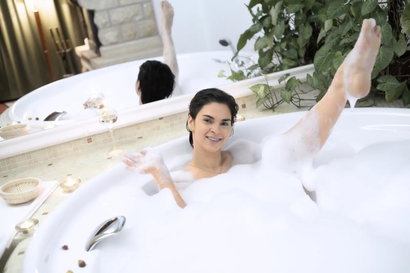 A woman enjoying a relaxing soak in a warm bath.